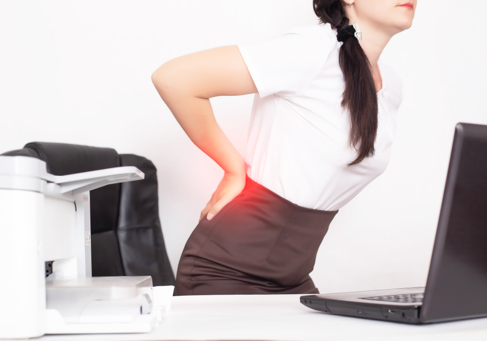 Girl,Office,Worker,Holding,Her,Aching,Back,From,A,Chair, Massage Therapy for Sciatica & Nerve Pain: How to Relieve Discomfort Naturally